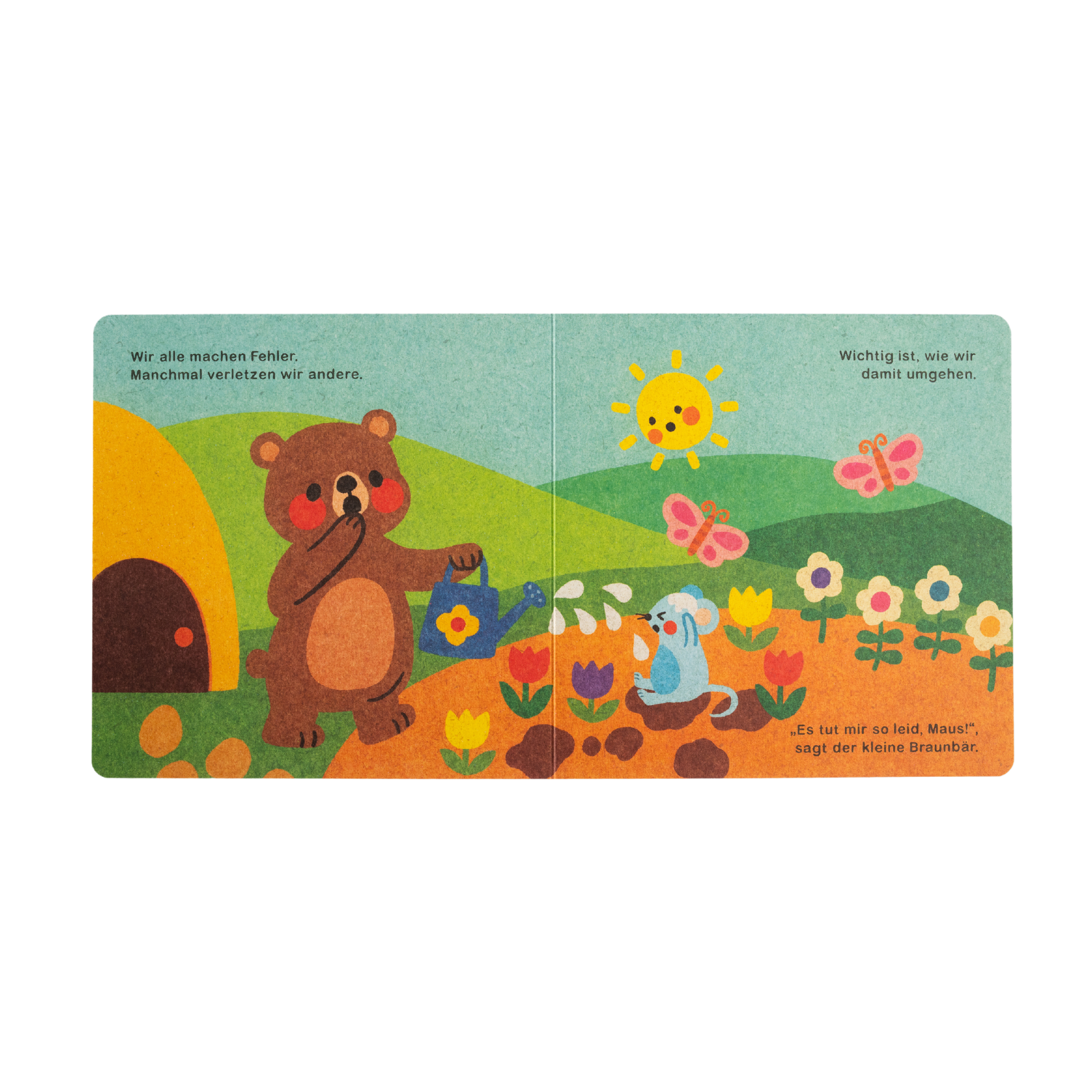 Das illustrierte Kinderbuch "Hilfe brauchen ist ok" von Annelies Draws zeigt einen Braunbären mit einer Gießkanne neben einem Bienenstock, Blumen und einer blauen Maus. Die Szene entfaltet sich im Sonnenschein mit Wolken, Schmetterlingen und Text am oberen und unteren Rand.