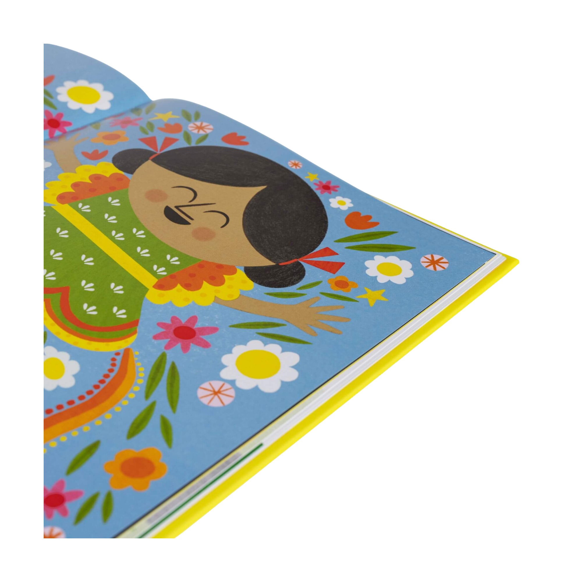 Ein aufgeschlagenes Kinderbuch zeigt eine bunte Illustration aus „Manchmal bin ich alles, was ich brauche“ von Juliana Perdomo: Ein fröhlich lachendes Kind mit schwarzen Zöpfen trägt ein grünes Kleid mit roten Details und ist von bunten Blumen auf blauem Hintergrund umgeben.