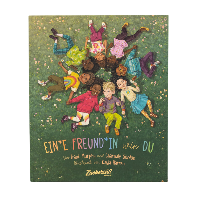 Das Cover von "Ein*e Freund*in wie du" von Frank Murphy & Charnaie Gordon zeigt Kinder, die in einem Kreis im Gras liegen, sich an den Händen halten und lächeln, als Symbol für Freundschaft. Der Titel und die Namen der Schöpfer sind angegeben.